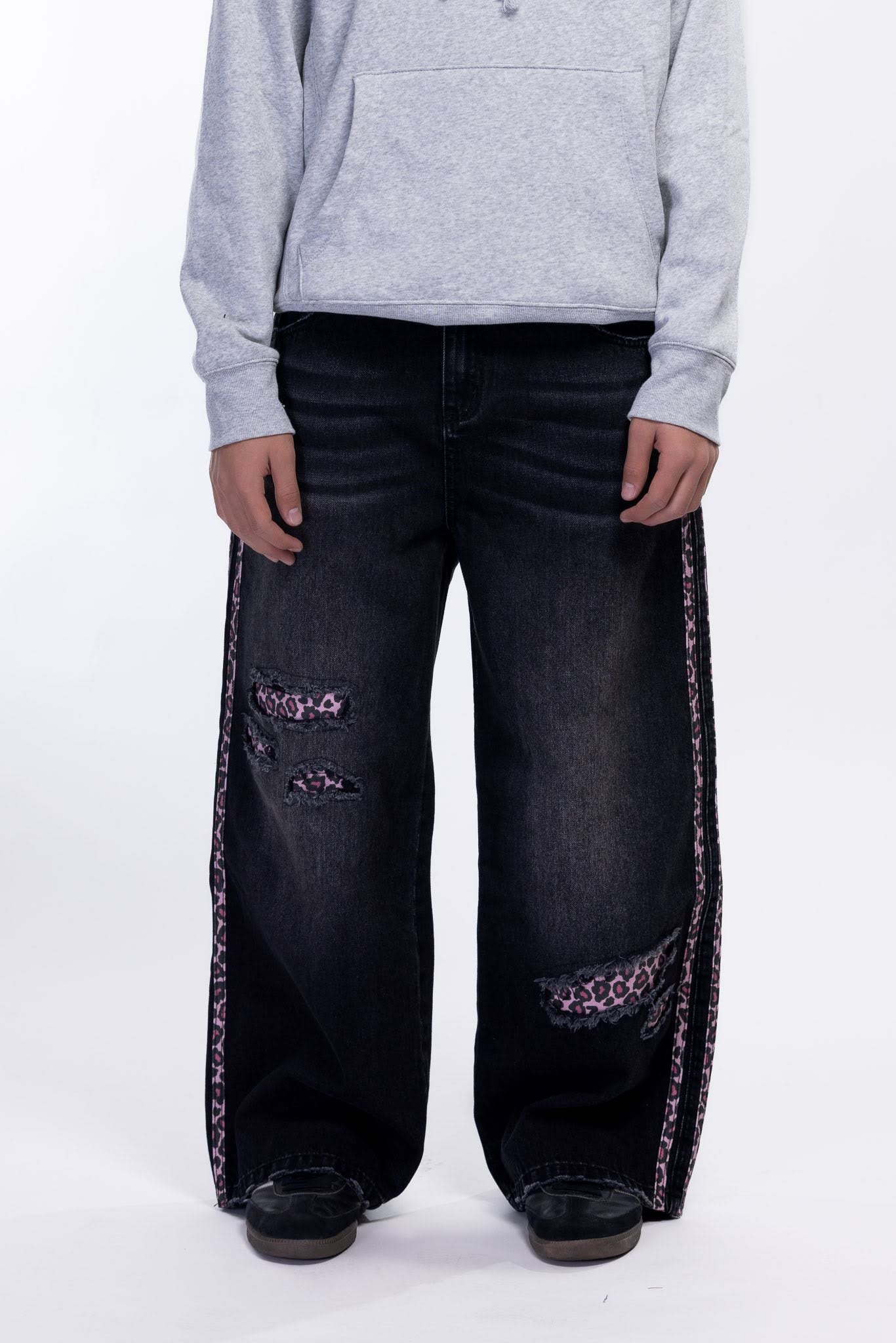 Black jeans with pink leopard print on a white background