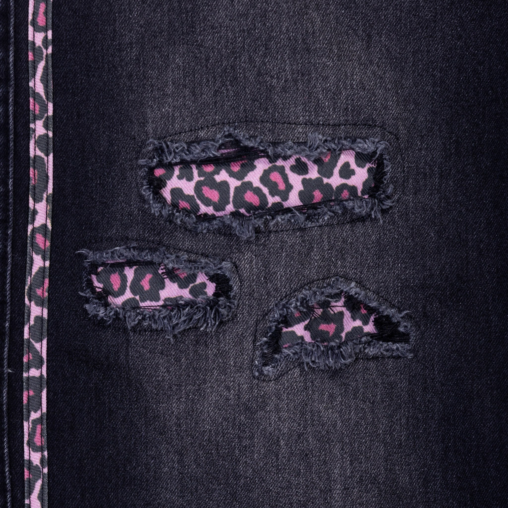 Black jeans with pink leopard print patches and side stripes