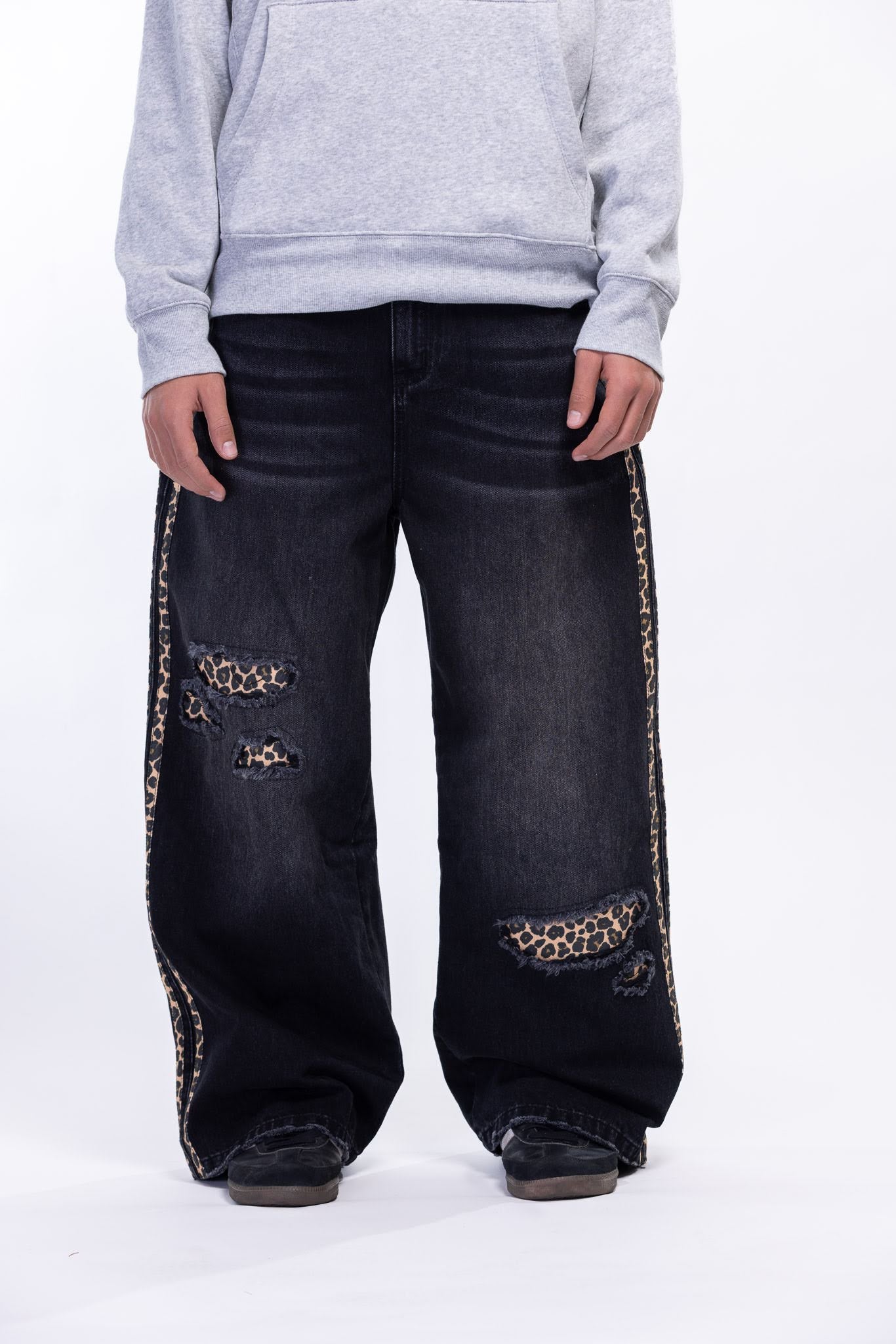 Black jeans with leopard print on a white background