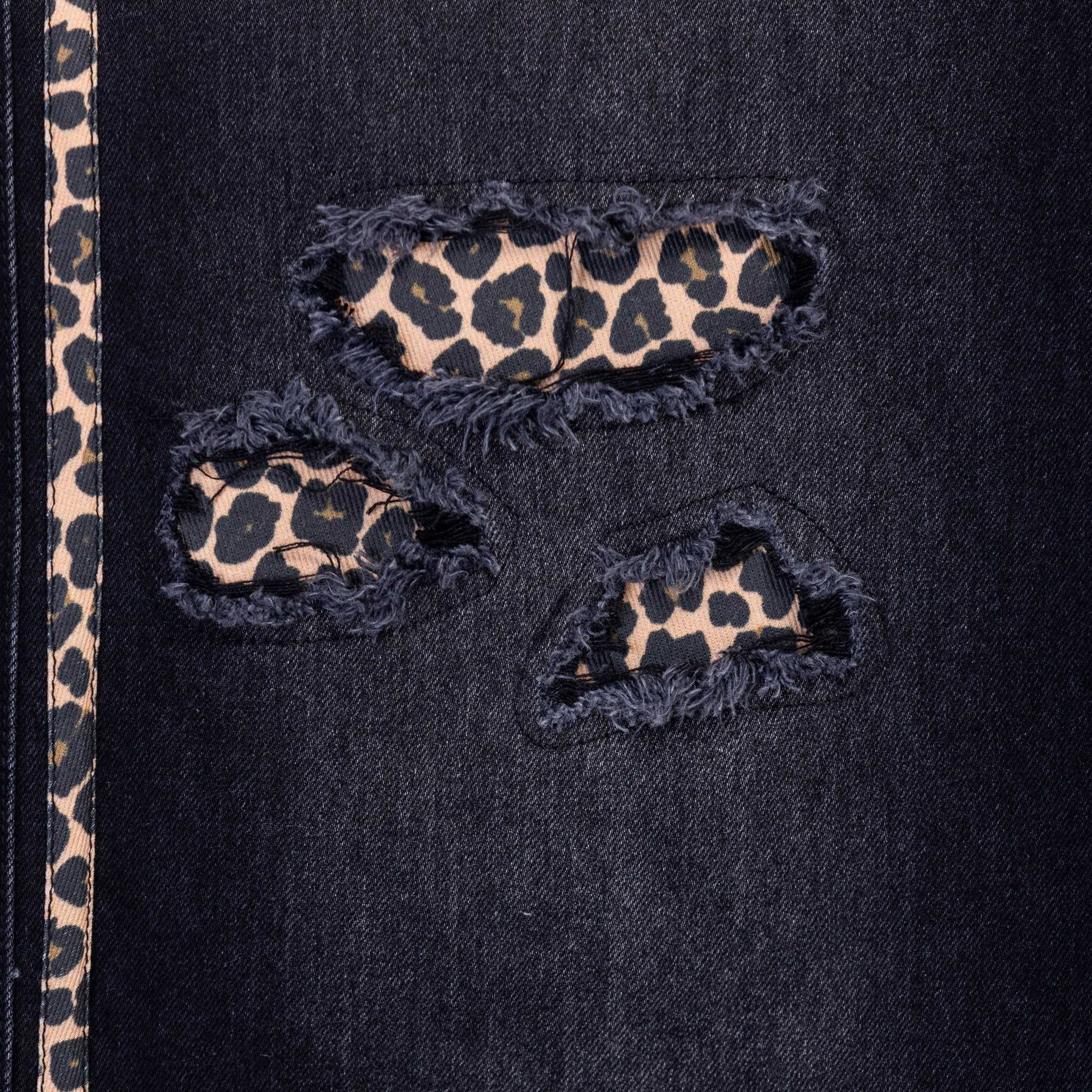 Black jeans with leopard print patches and a strip on the side