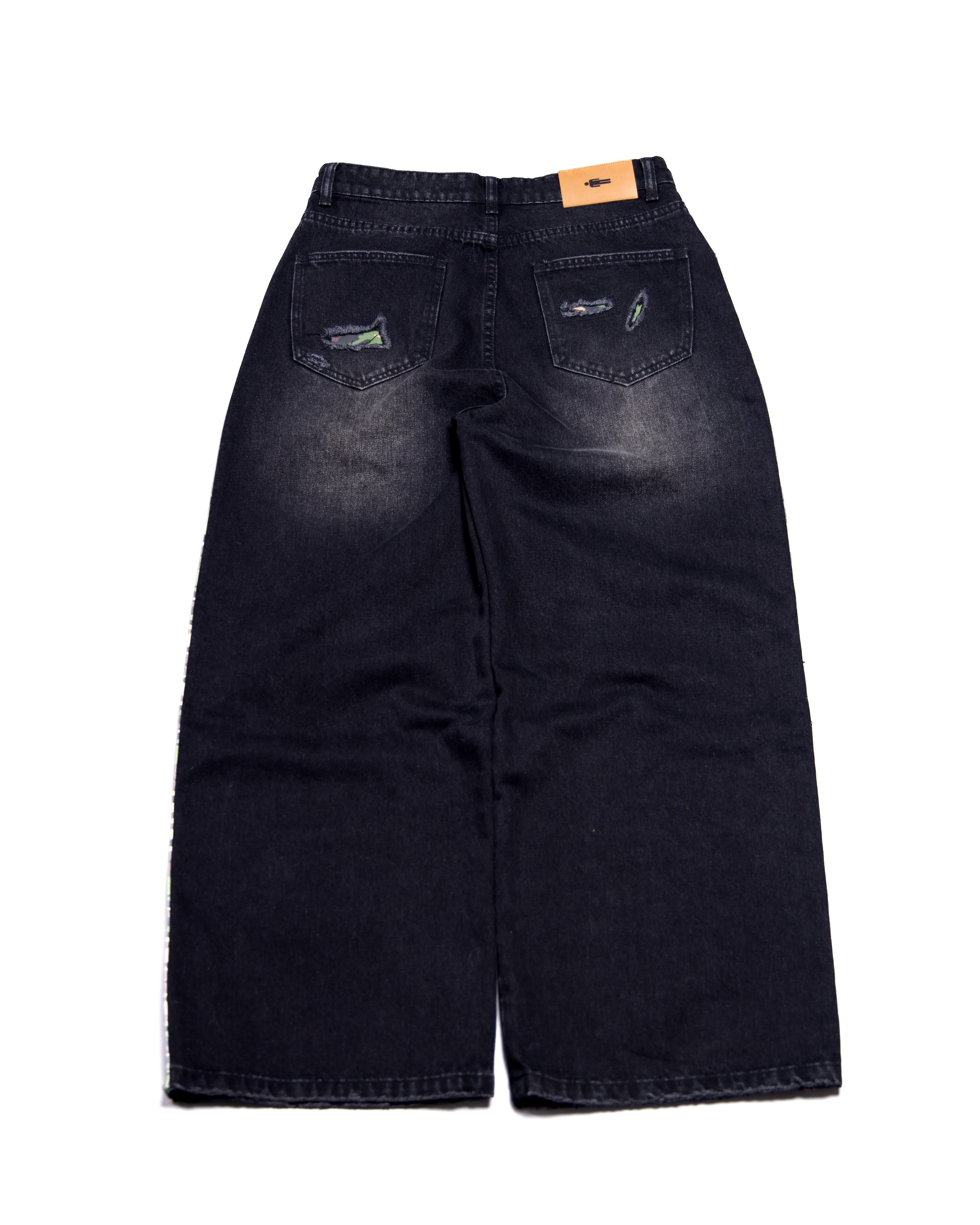 Black distressed jeans on a white background