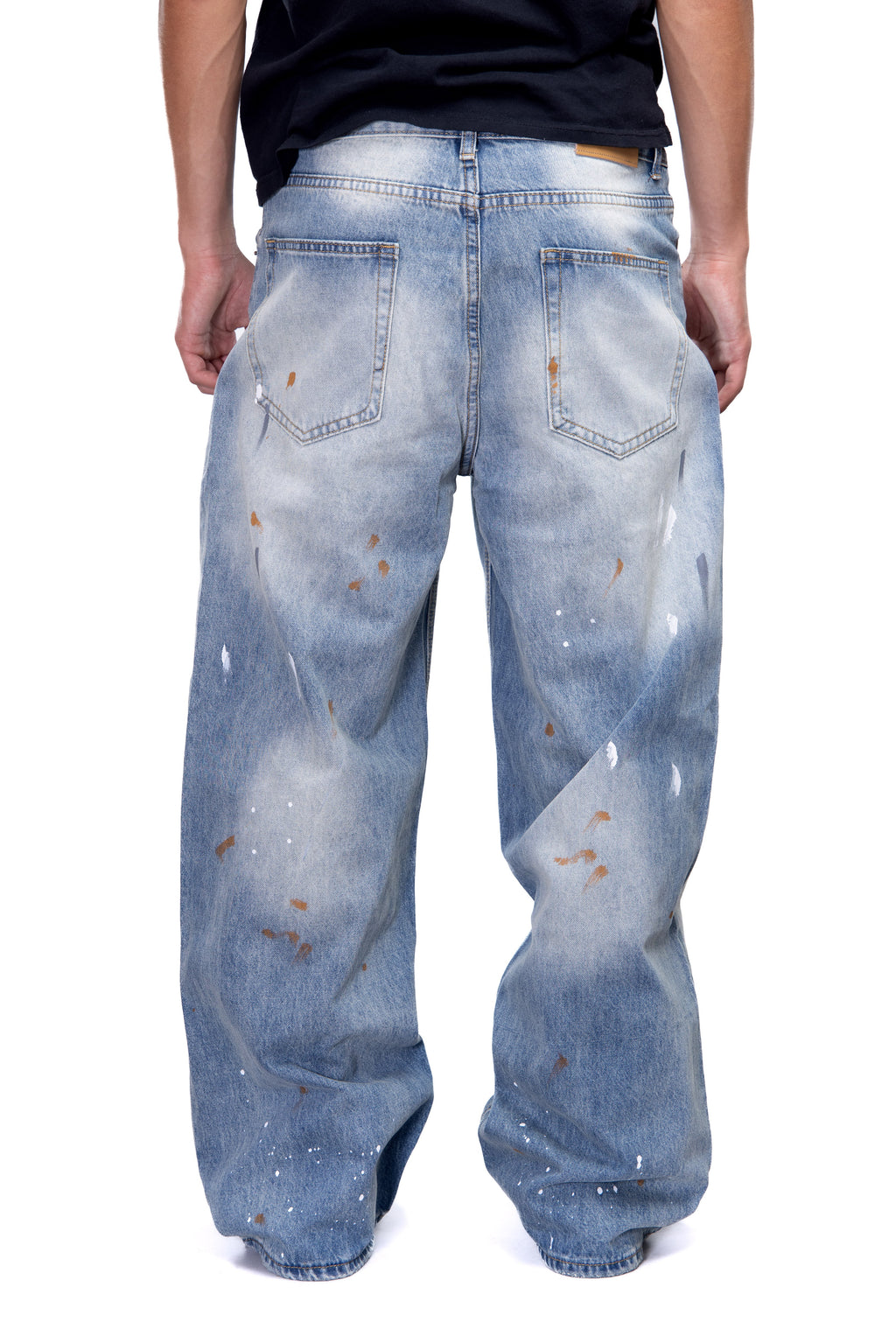Blue distressed jeans worn by a person on a white background