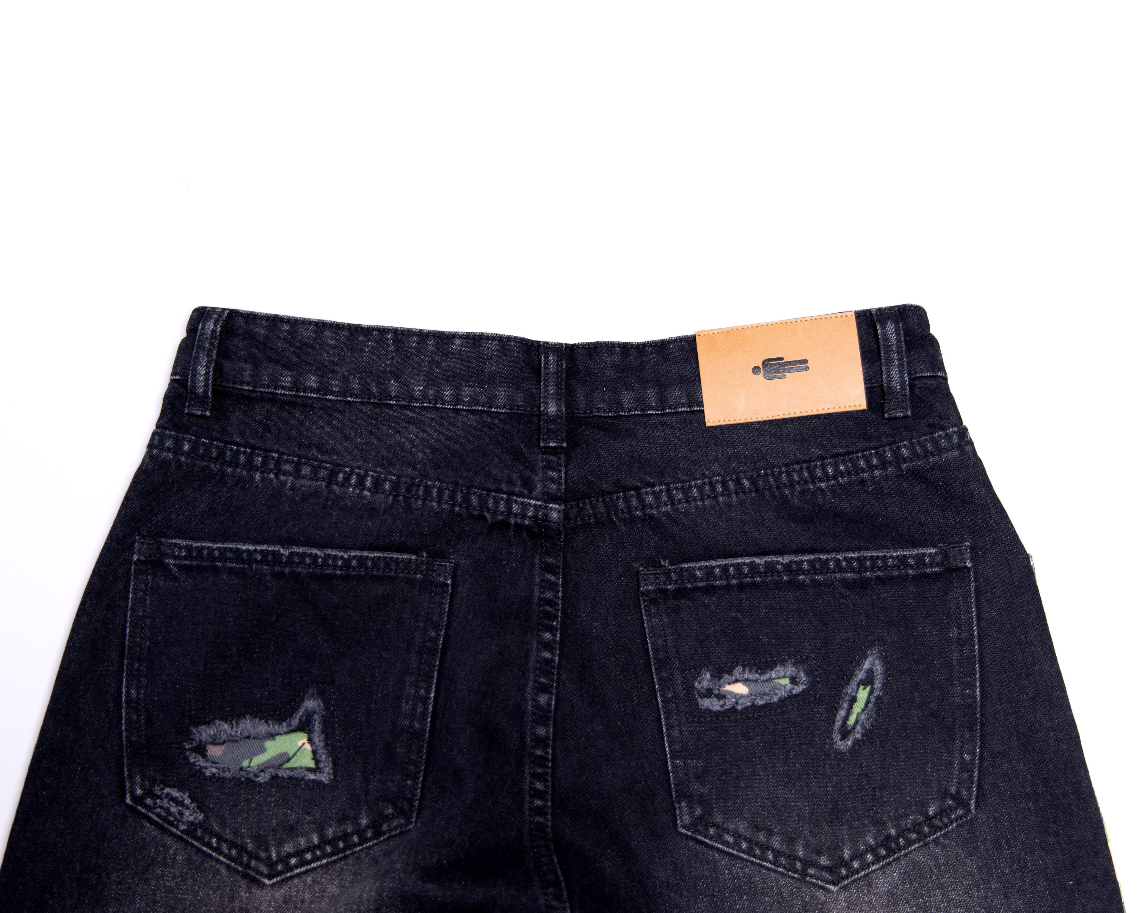 Black denim jeans with patchwork design on a white background