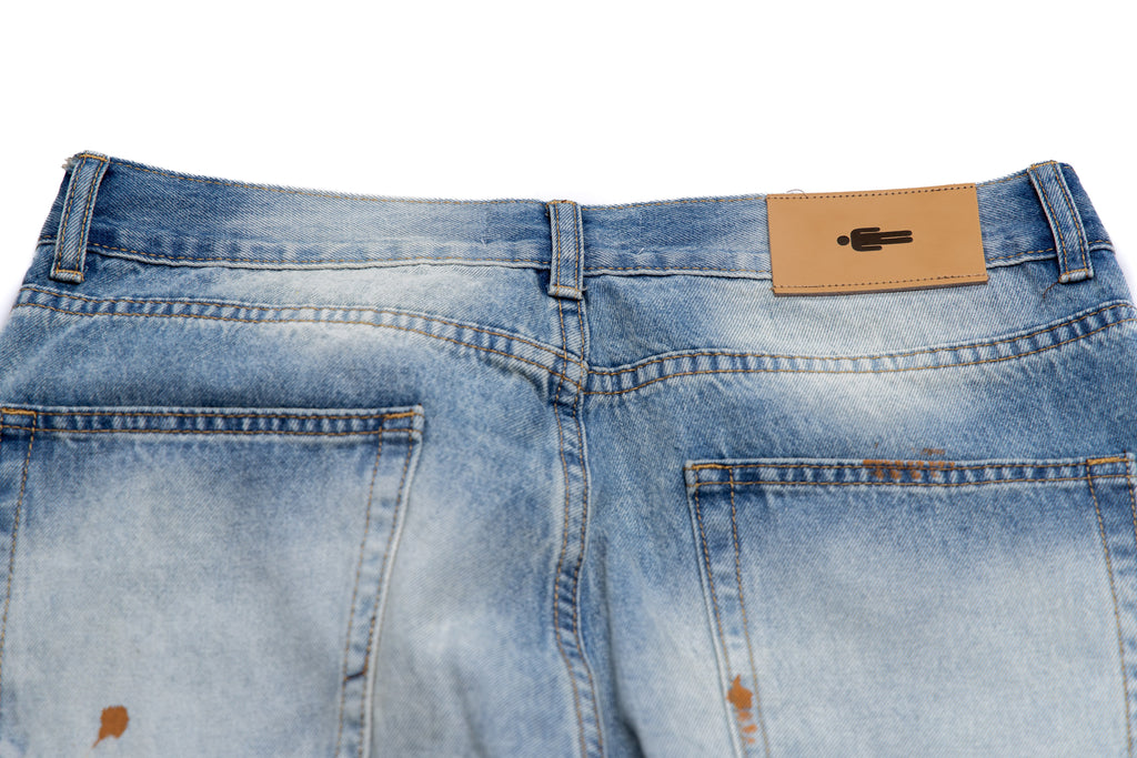 Close-up of blue jeans with a brand label on the back pocket.