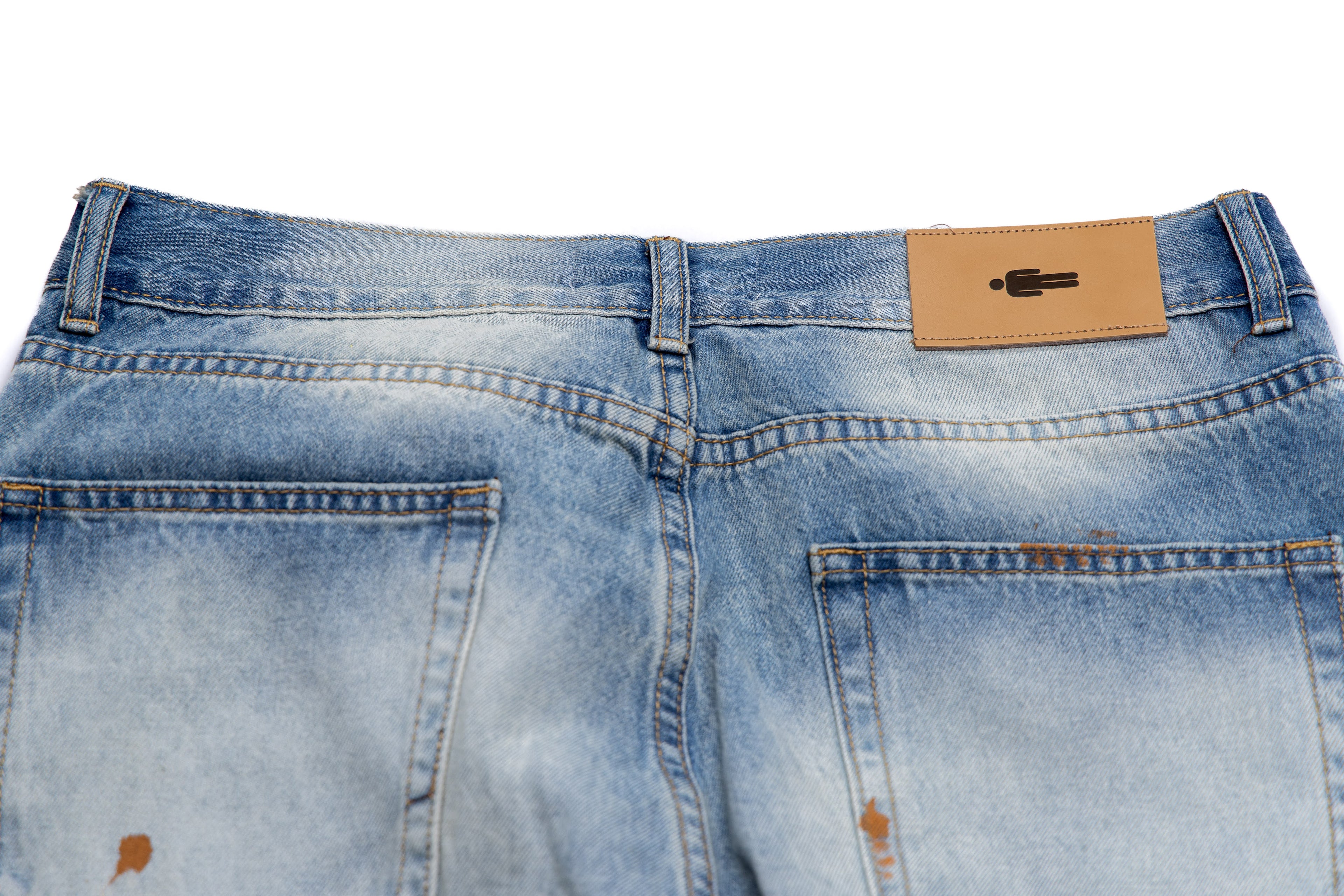 Close-up of blue jeans with a brand label on the back pocket.