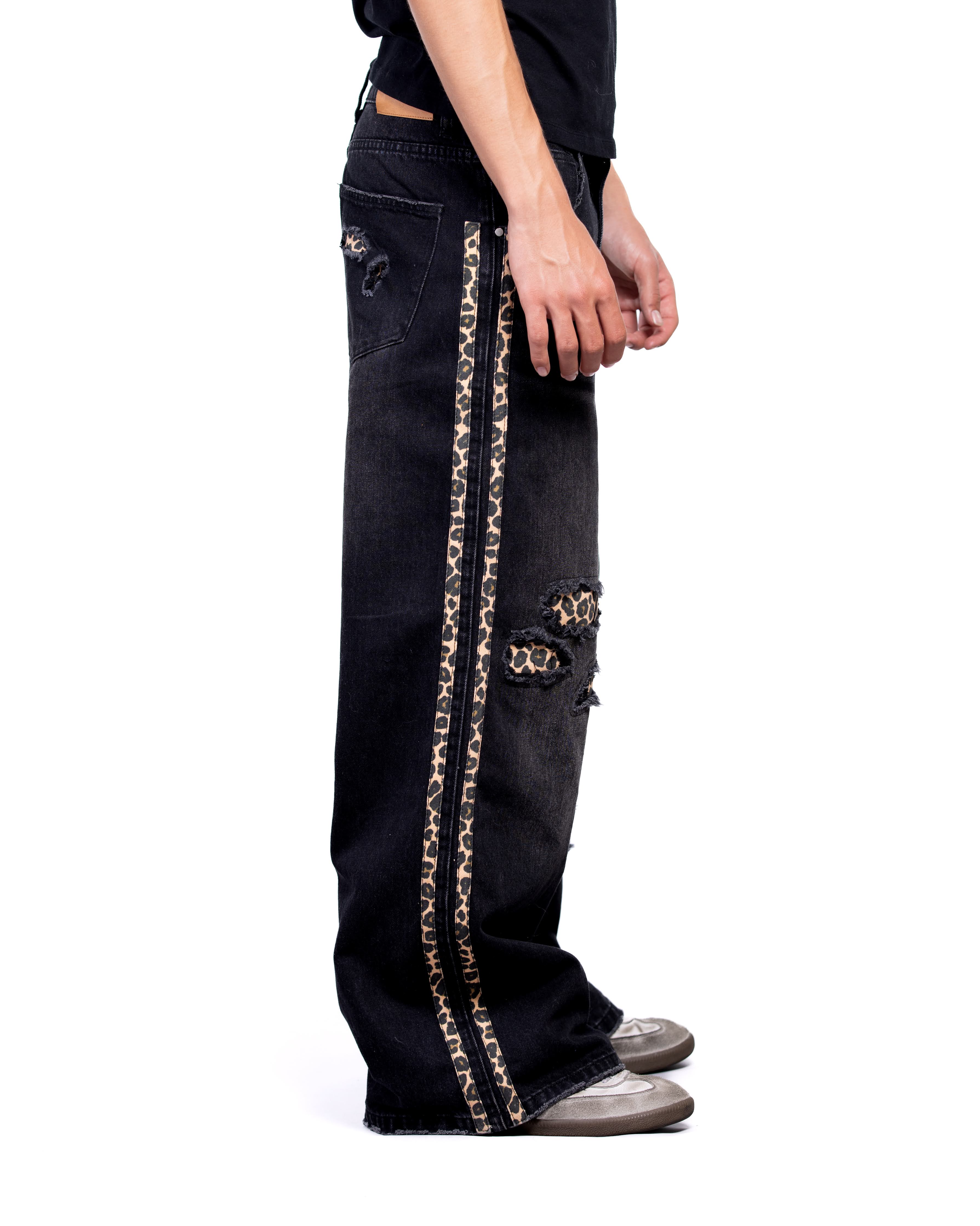Black jeans with gold chain design on a white background